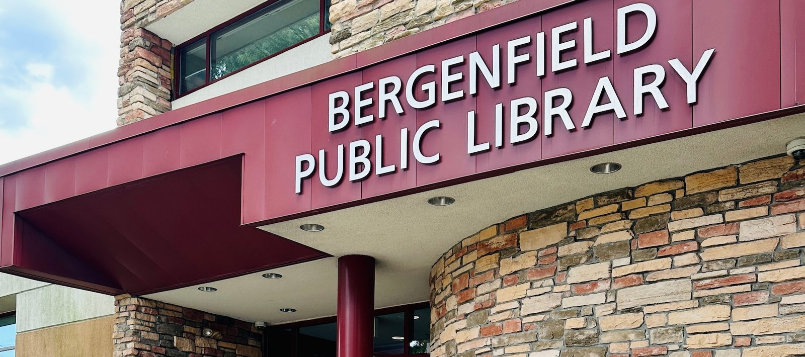 The entrance canopy and stone facade of Bergenfield Public Library.