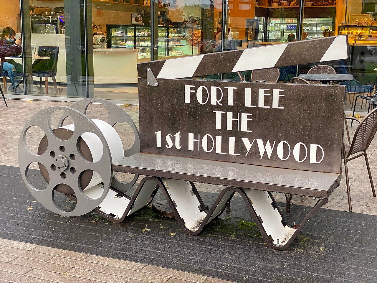 A Fort Lee bench shaped like a movie clapperboard and film reels, reading The 1st Hollywood.